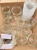 Top view of box containing multiple clear glass jars