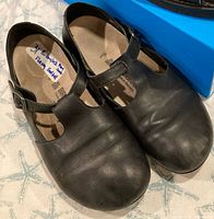 Top view of both shoes showing leather uppers and buckle straps