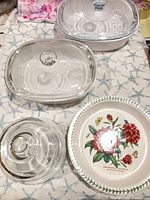 Group view of two CorningWare casseroles, Portmeirion pie dish and marble cheese server with dome