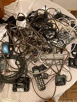 Overview of tangled cords, phone handsets, power bar