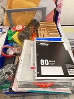 Overall view of mixed office supplies inside box