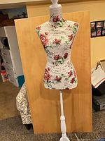 Front view of floral dress form on stand