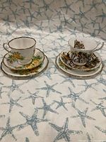 Two complete teacup and saucer sets with dessert plates