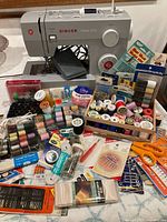 Singer 4423 machine with extensive sewing supplies spread out