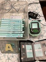 Lot overview showing Slice cutter, adapter, design card cases, mat, storage bin