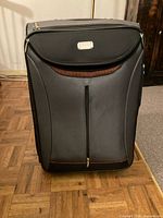 Front view of Dionite suitcase closed showing exterior and front pocket