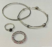 overview of two silver bangles and two rings