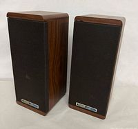 Front view with grills on showing wood veneer finish