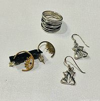 All items overview: sterling ring stack, eye hoop earrings, cat dangle earrings