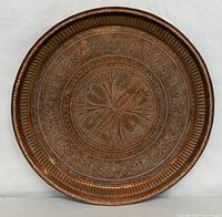 Front view showing full engraved design and rim detail