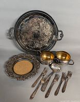 Group shot showing all ten silver-plated pieces