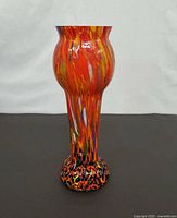 Full view of the tall multicolor art glass vase