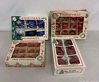 Four boxes of vintage glass ornaments, assorted colors and counts