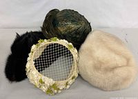 Group shot of all four hats