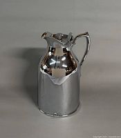 Front view of chrome Thermos carafe