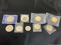 Group shot of all ten commemorative coins and tokens