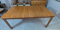 Full view of rectangular oak dining table with top panels