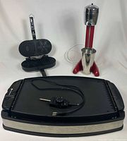 All three appliances grouped: grill in foreground, drink mixer and pizzelle maker behind