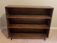 Front view of wooden three-shelf bookcase
