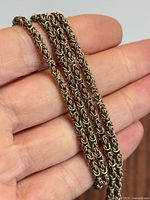 Close-up of woven gold chain links