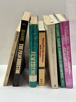 Front view of seven filmmaking books standing upright showing spines