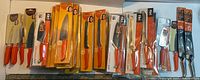 Assorted orange-handled Furi Rachael Ray knives and shears, packaged