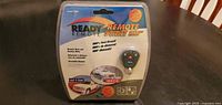 Front of sealed Ready Remote model 23923 package showing product name, key fob, features