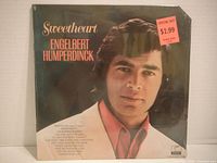 Front of sealed LP jacket showing artwork, shrink wrap, price sticker