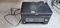 Full view of Epson WorkForce WF-2830 printer with power cord attached