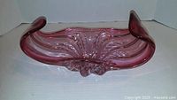 Top view of purple art glass dish showing curled ends and interior pattern