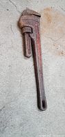 Full view of Ridgid pipe wrench on concrete floor