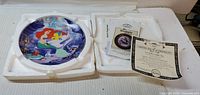 Front view of Ariel collector plate with certificate and styrofoam