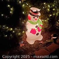 Snowman blow mold illuminated at night, showing overall appearance lit