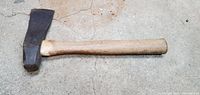 Full view of hatchet lying flat, handle and head visible