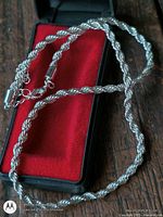 Full view of 16 inch silver plated rope chain necklace on red box