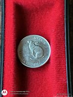 Reverse of 1967 Canada 5-cent coin with rabbit design in red presentation case