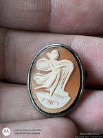 Front view showing carved shell cameo and silver bezel