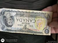 Obverse of Canadian $1 bill showing Queen Elizabeth II portrait and serial prefix BEF