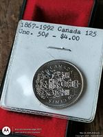 Coin in holder showing reverse with Canadian coat of arms, label notes 1867-1992 Canada 125 Unc. 50¢