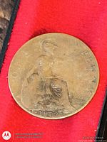 Bronze coin with seated Britannia reverse dated 1873 on red background