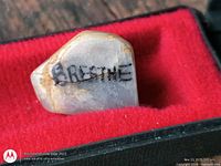 Polished quartz stone in case showing engraving