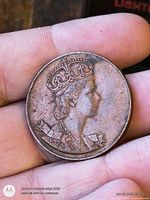 Obverse showing crowned portrait of Queen Elizabeth II on copper medallion