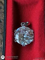 Front view of pendant showing round brilliant clear stone in six-prong silver-tone setting