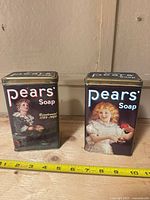 Front view of both Pears Soap tins showing child illustrations and logos