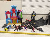 Wide shot of all items: Daily Planet playset, two Batmobiles, assorted figures