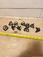 Group of ten cast iron heart napkin holders with tape for scale