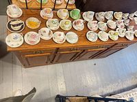 Overhead view of entire assortment of teacup and saucer sets on wooden surface