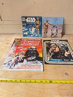All four Star Wars publications with measuring tape for scale
