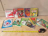 Group shot of all books with tape measure for scale