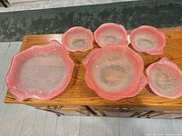 Full set of six Mikasa pink art glass pieces on table